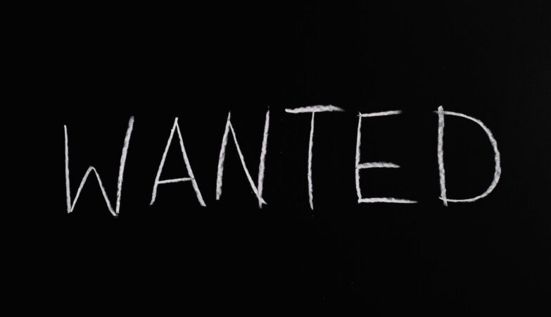 wanted lettering text on black background